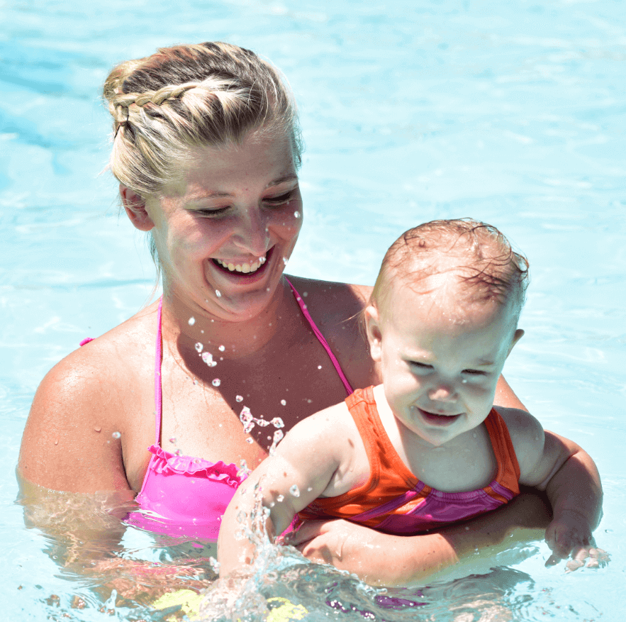 A happy community member and her child in the pool